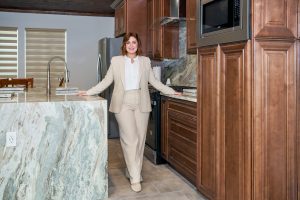Texas real estate professional sharing real estate insights and guidance standing in a kitchen